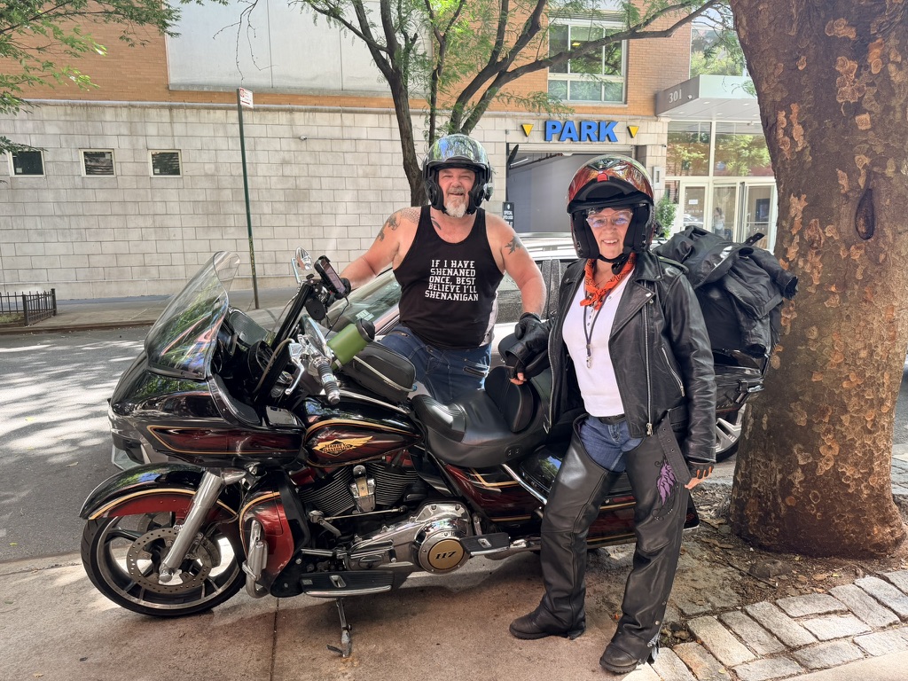 Molley Marlena with her husband and their motorcycle